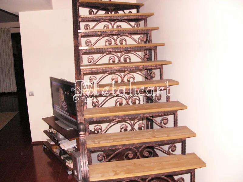 Balustradă interioară cu volute mari și finisaj cupru-patinat.