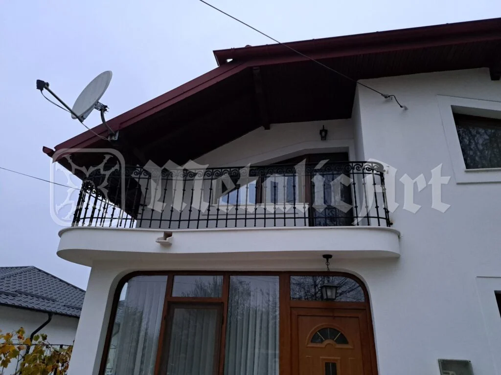 Colțul balconului, cu balustrada și streașina casei.