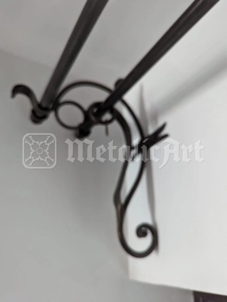 Suportul de galerie în volută, cu cele două bare prinse în el.
