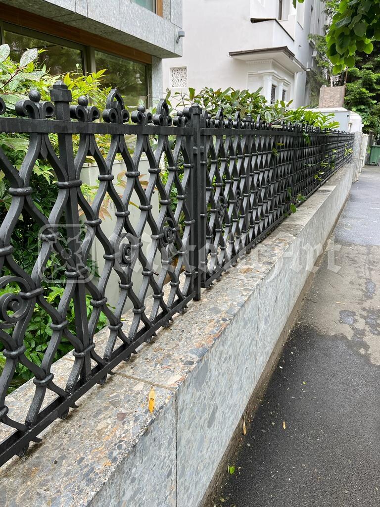 Gardul cu împletitură de ochiuri, de-a lungul trotuarului.