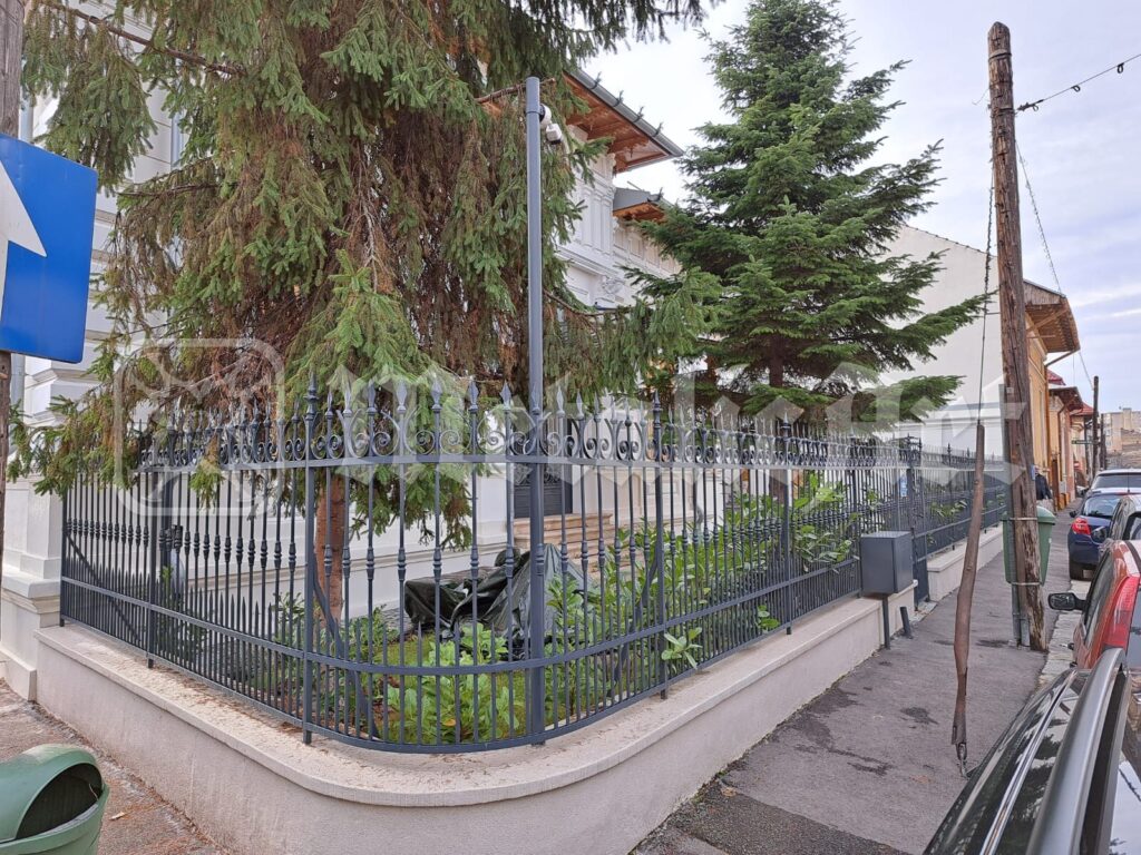 Gardul restaurat la colțul străzii, de-a lungul casei vechi.