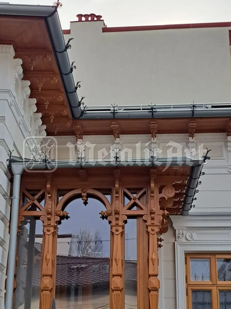 Streașina și stâlpii de lemn ai pridvorului, după restaurare.