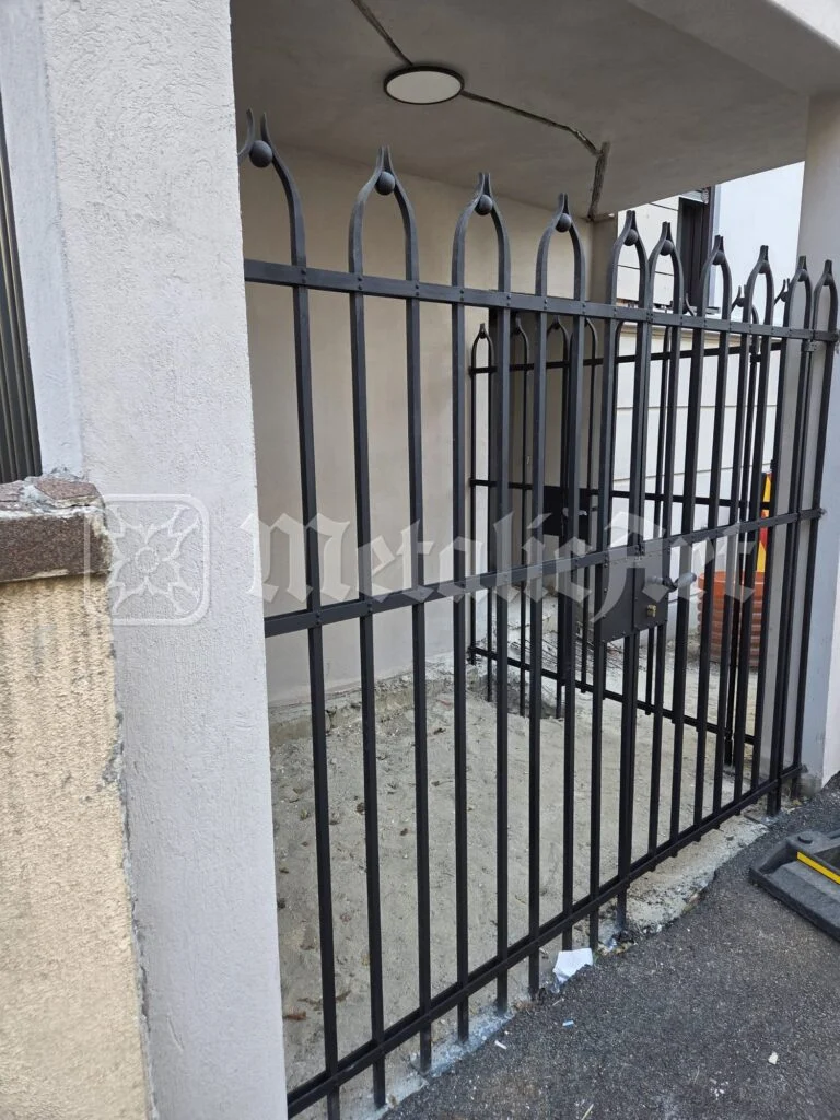 Portiță din fier forjat cu arcade ogivale, sub gangul de trecere.